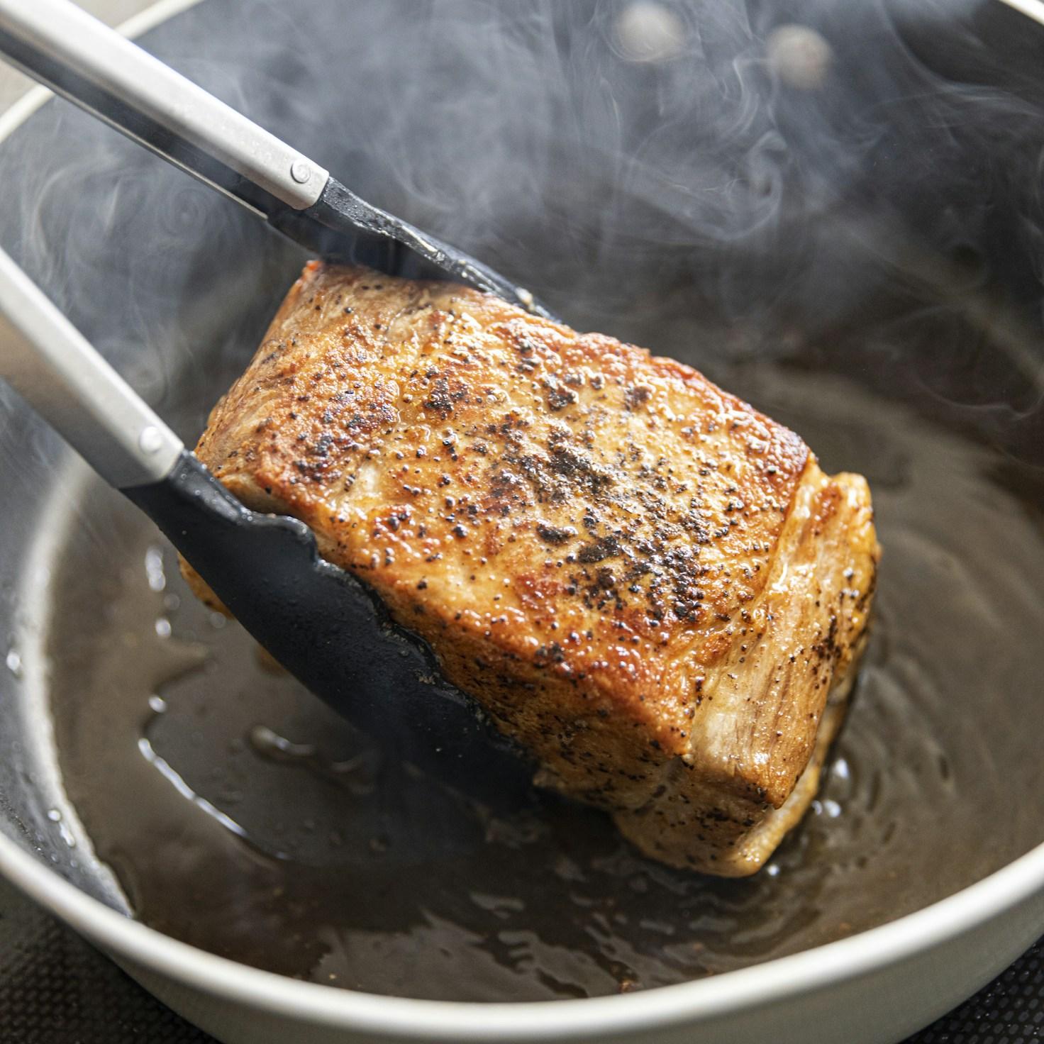 Diverse group of community members sharing a meal together, showcasing the social bonds formed through collaborative cooking